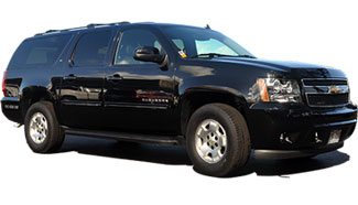 A bride being helped out of limousine by chauffeur